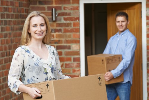 Moving team preparing a safe removal job with boxes and protective materials