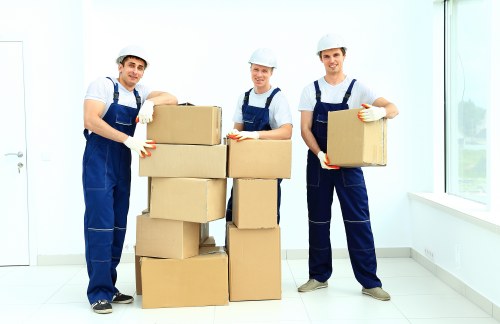 Moving team protecting furniture during an insured house move in Enfield