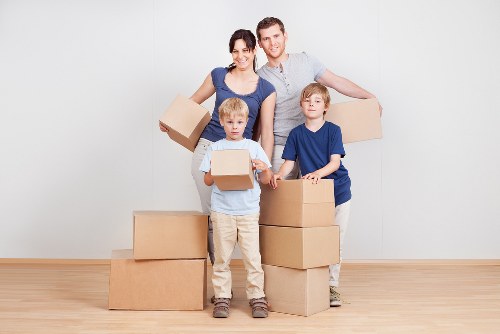Packed boxes and furniture prepared for a home move in a North London property
