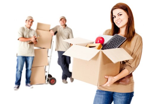 Professional movers handling furniture and packed boxes