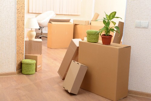 Professional movers handling household items in an Enfield street